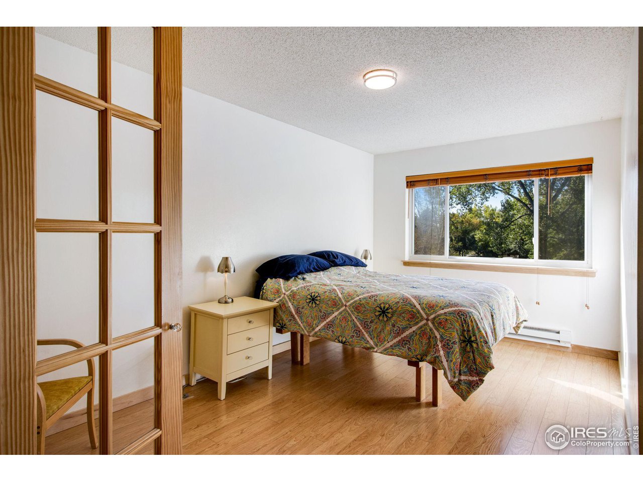 2659 Juniper Avenue, Unit 30 Boulder, CO 80304 - Photo 15 of 35 a living room with a bed furniture and a large window