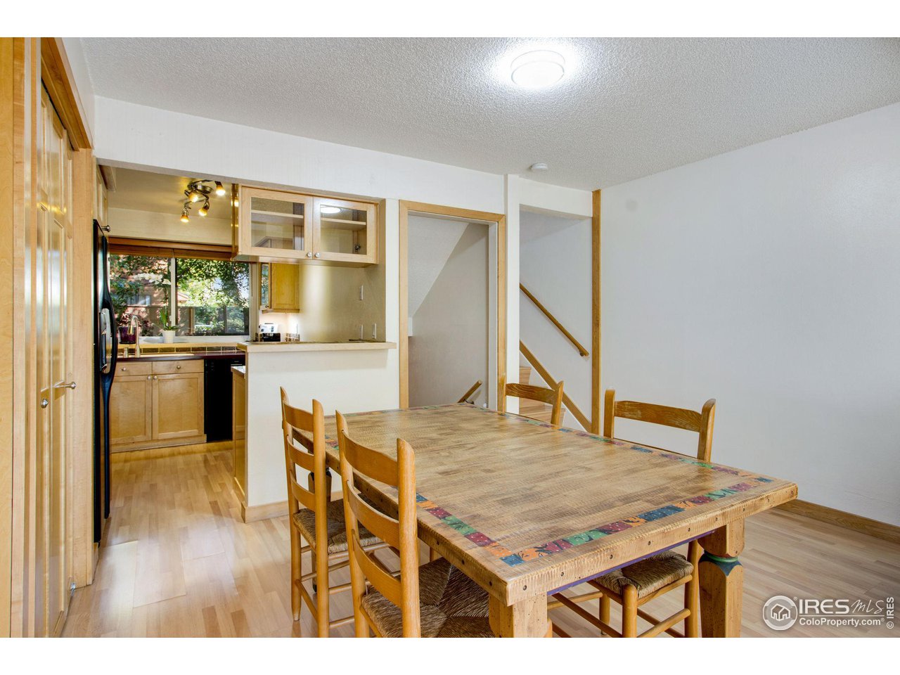 2659 Juniper Avenue, Unit 30 Boulder, CO 80304 - Photo 8 of 35 a room with kitchen island a table and chairs in it