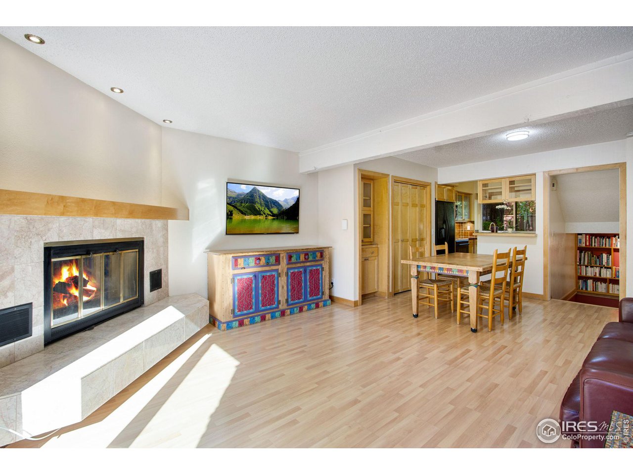 2659 Juniper Avenue, Unit 30 Boulder, CO 80304 - Photo 10 of 35 a living room with furniture a fireplace and a flat screen tv