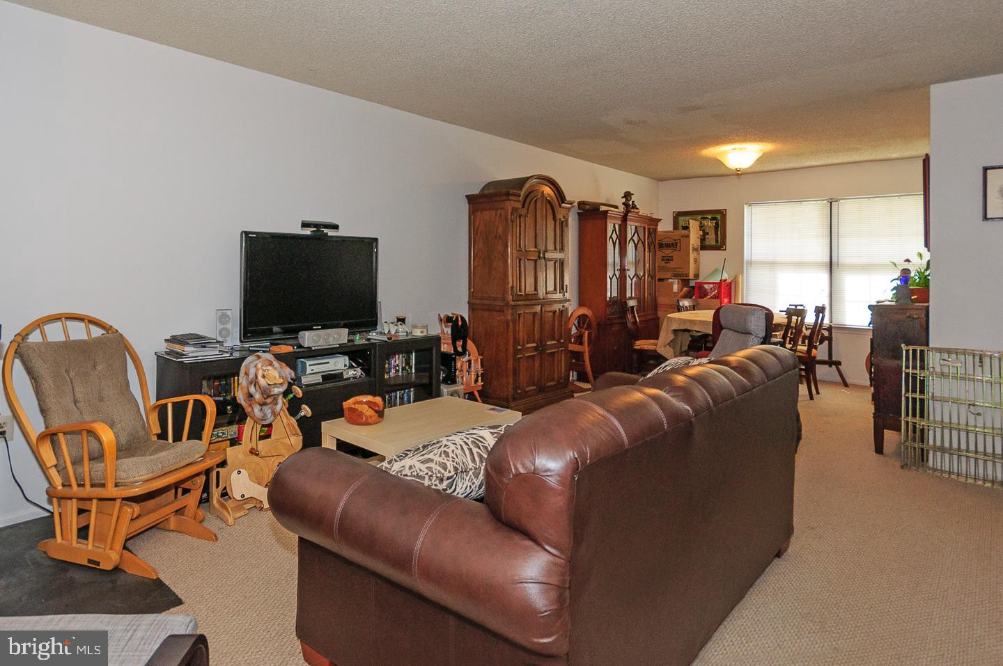 2 Stout Court Lawrence Township, NJ 08648 - Photo 2 of 13 a living room with furniture and a flat screen tv