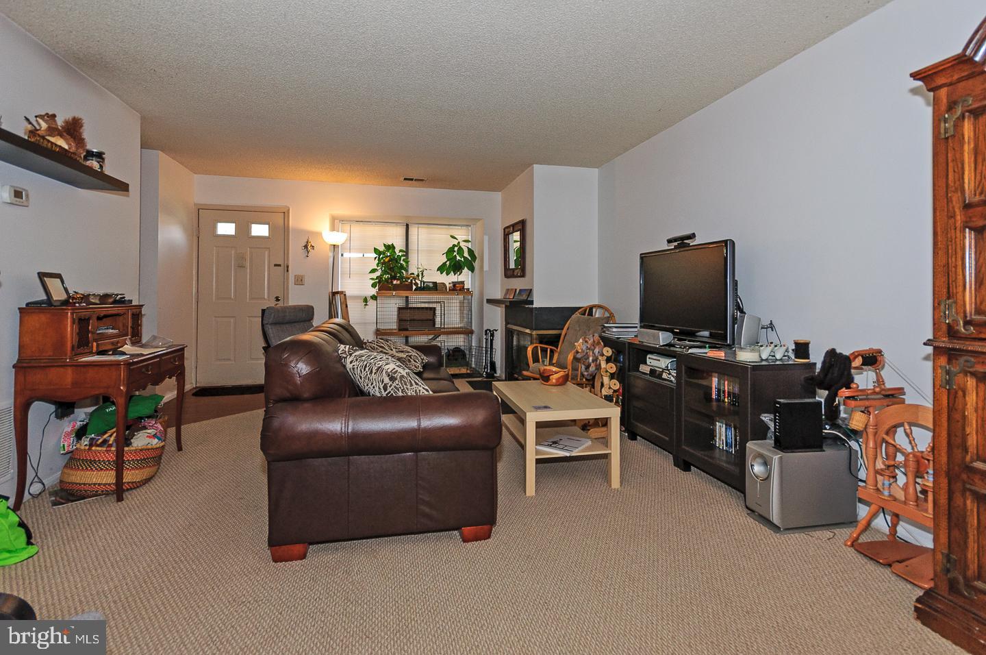 2 Stout Court Lawrence Township, NJ 08648 - Photo 3 of 13 a living room with furniture and a flat screen tv