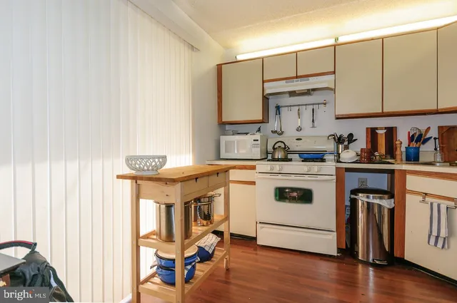 a kitchen with a stove a sink and a microwave