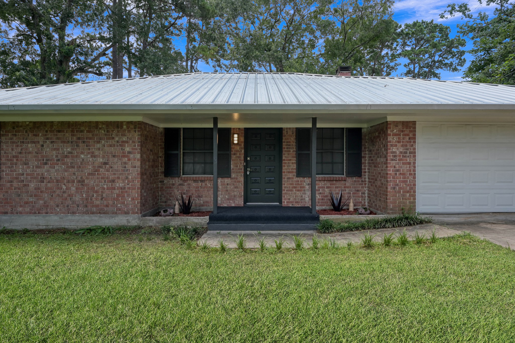 13544 Northshore Loop Conroe, TX 77304 - Photo 1 of 34 Brick home featuring a brand-new metal roof