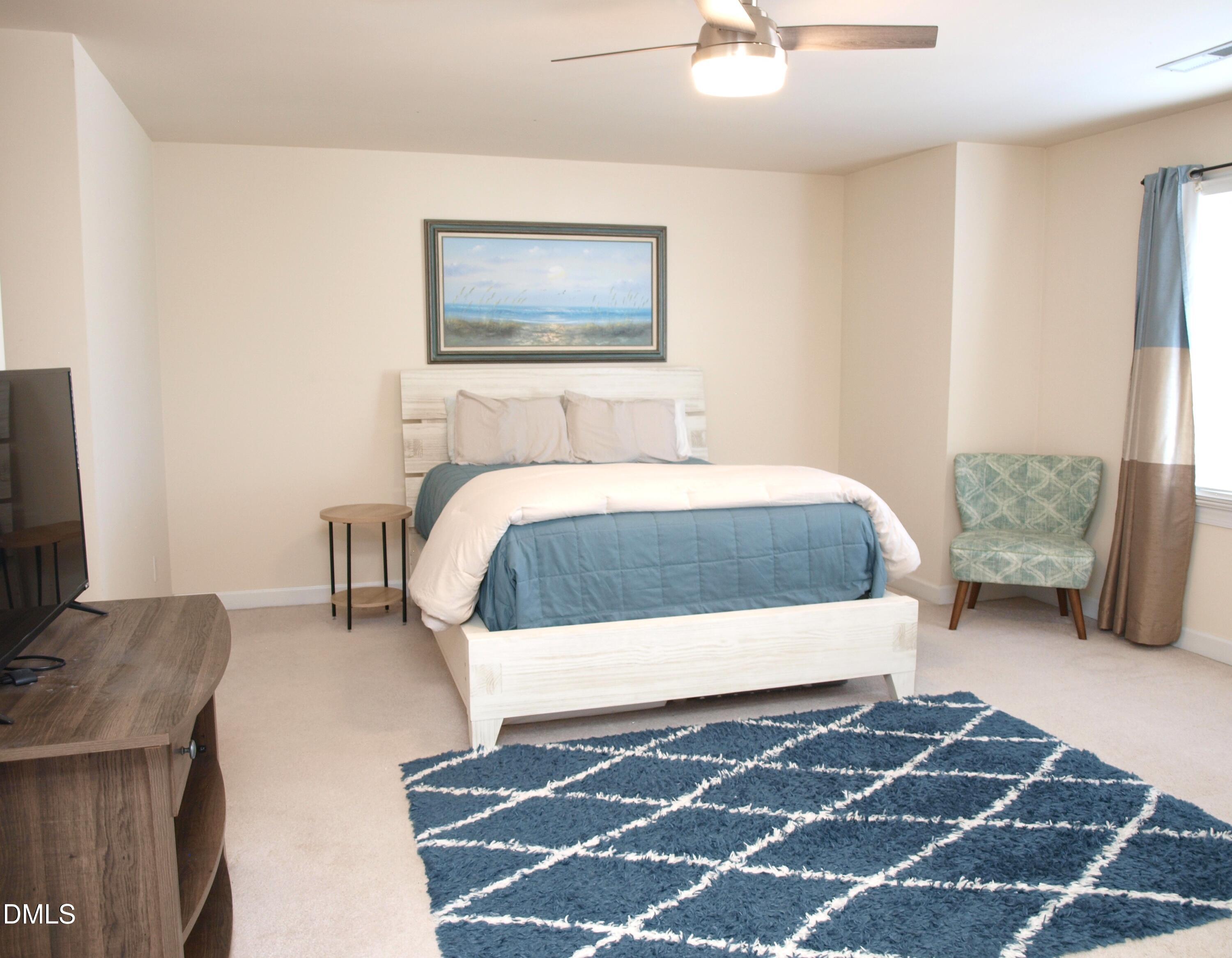 5206 Rio Grande Drive Raleigh, NC 27616 - Photo 21 of 37 a bedroom with a bed and a couch