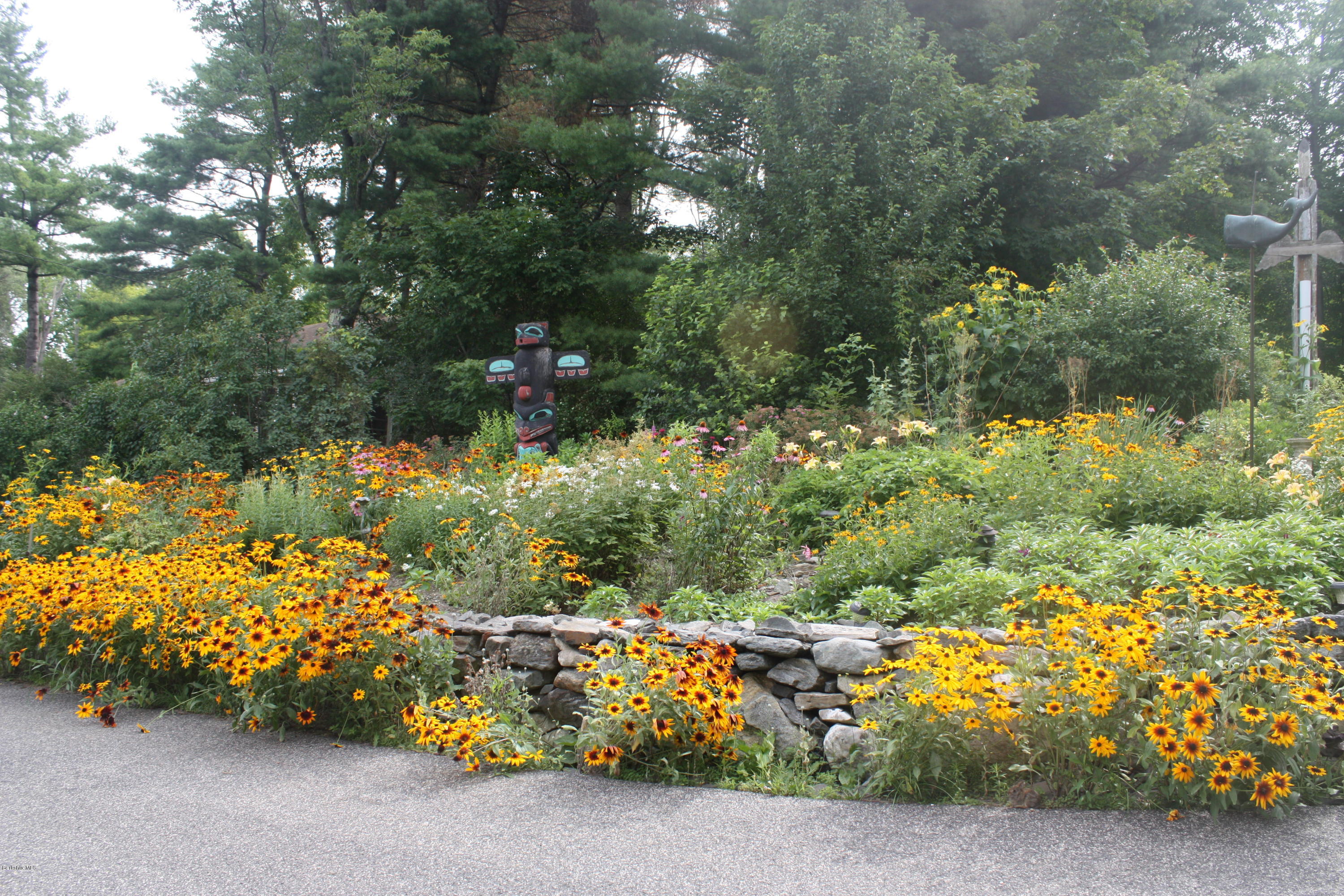 17 Mahkeenac Road Stockbridge, MA 01262 - Photo 40 of 46 a view of a bench in the middle of a yard
