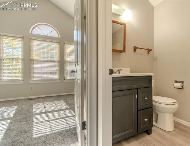 a bathroom with a toilet sink and a mirror