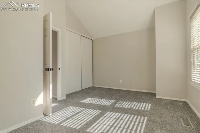 a view of a room with wooden floor and a bathroom