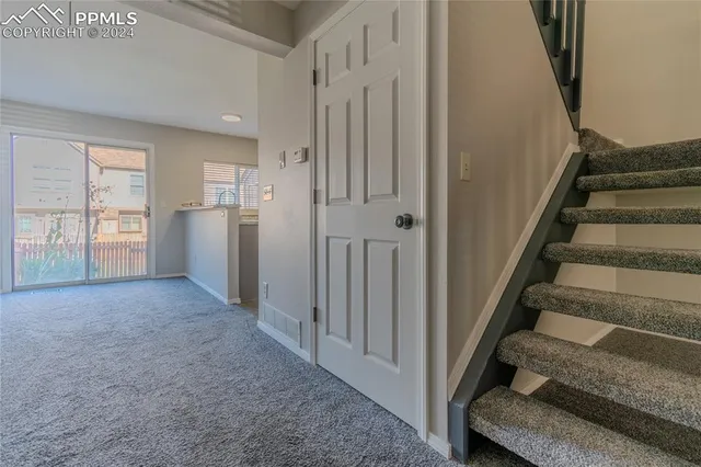 a view of entryway with wooden floor and stairs
