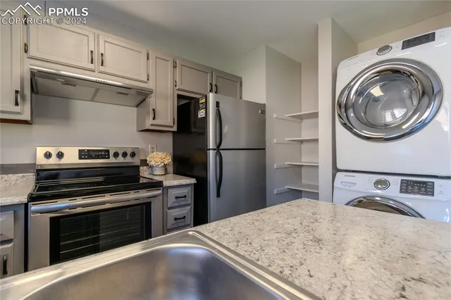 a kitchen with a stove and a refrigerator
