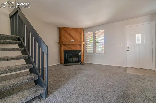 a view of an empty room with stairs