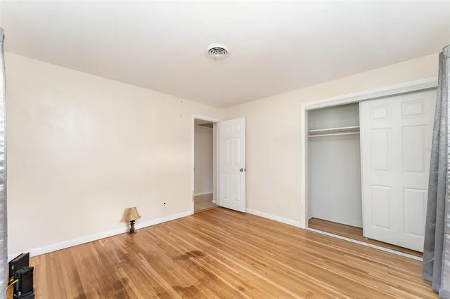 a view of a room with wooden floor and white walls
