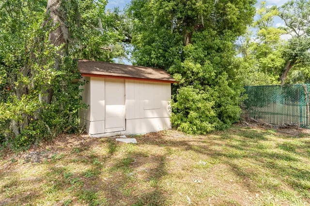 a backyard of a house with large trees
