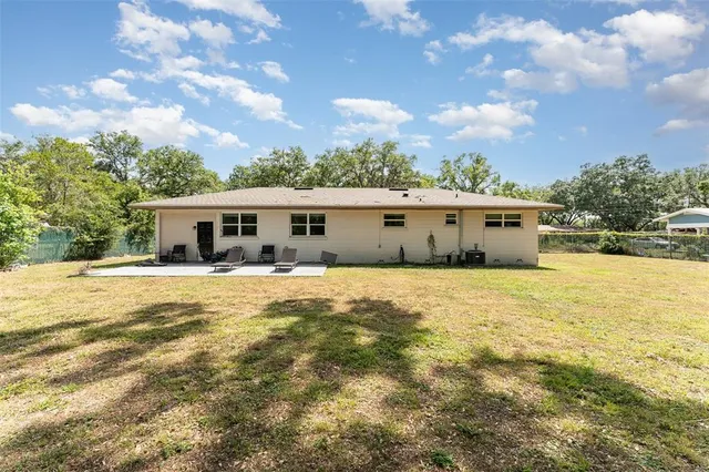 a view of house with outdoor space and swimming pool