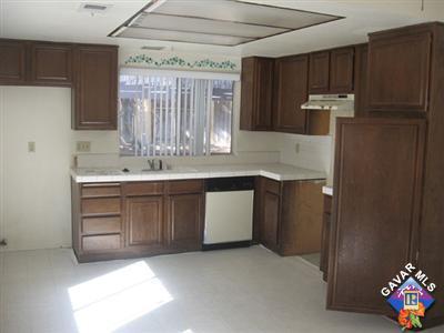 44025 Glenraven Road Lancaster, CA 93535 - Photo 3 of 5 a kitchen with a sink refrigerator and cabinets