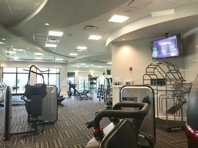a living room with furniture a flat screen tv and outdoor seating