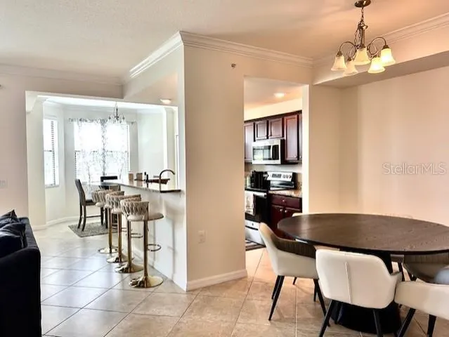 a view of a dining room with furniture and a chandelier