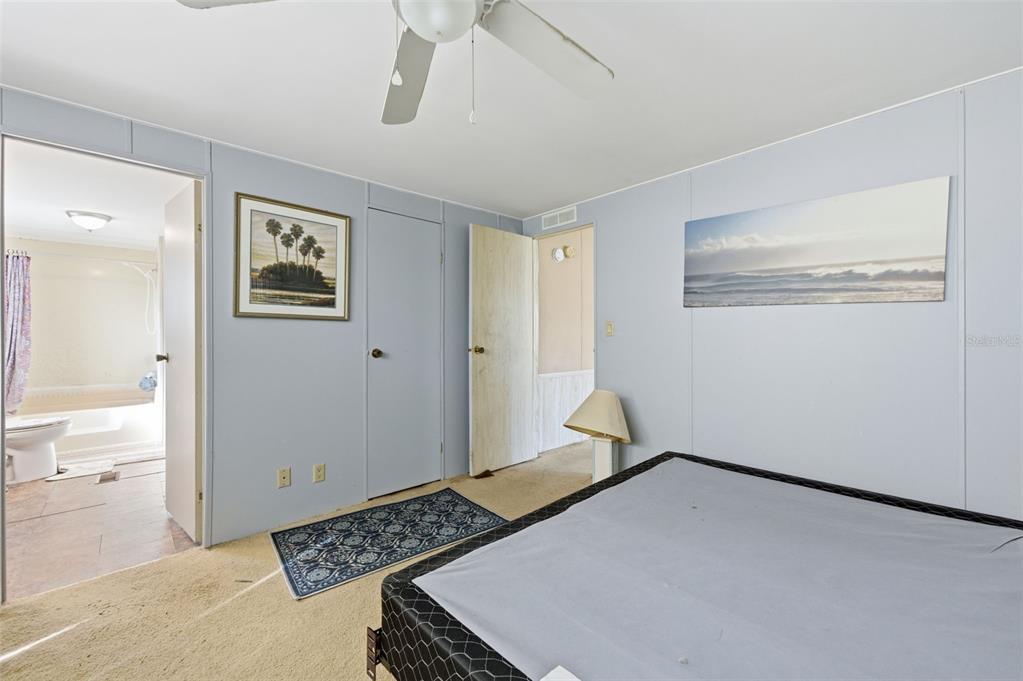 8045 Indian Trail Road Weeki Wachee, FL 34613 - Photo 5 of 49 a bedroom with a bed and a view of kitchen