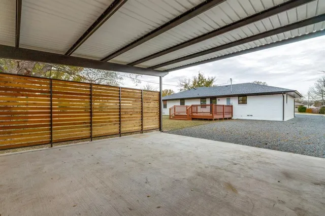 a backyard of a house with barbeque oven table and chairs
