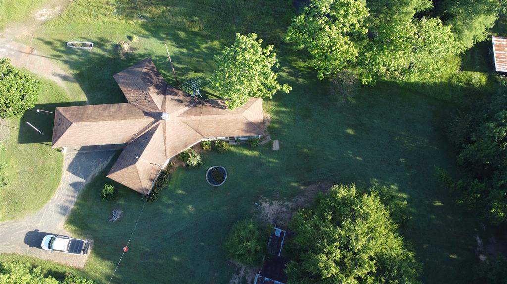 1111 Gilmer Road Winnsboro, TX 75494 - Photo 11 of 11 a backyard of a house with lots of green space