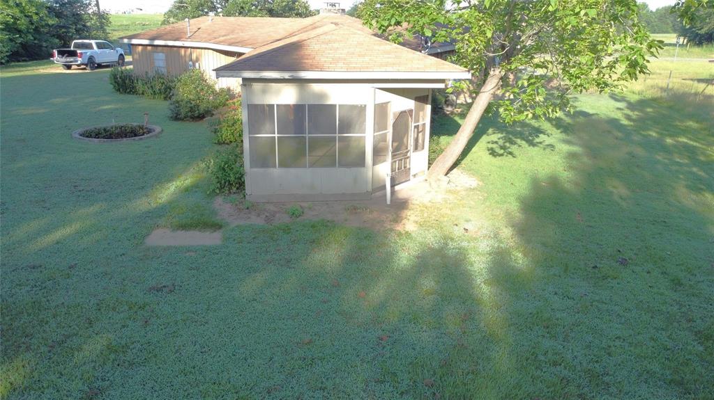 1111 Gilmer Road Winnsboro, TX 75494 - Photo 3 of 11 a view of a house with a yard