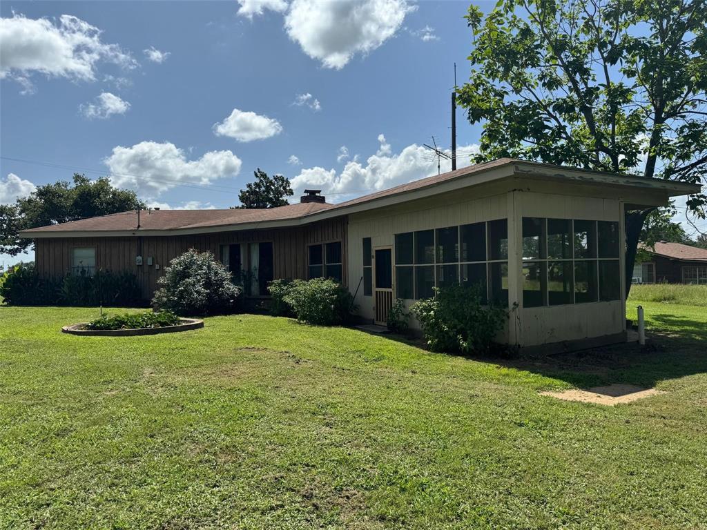 1111 Gilmer Road Winnsboro, TX 75494 - Photo 6 of 11 a front view of a house with garden
