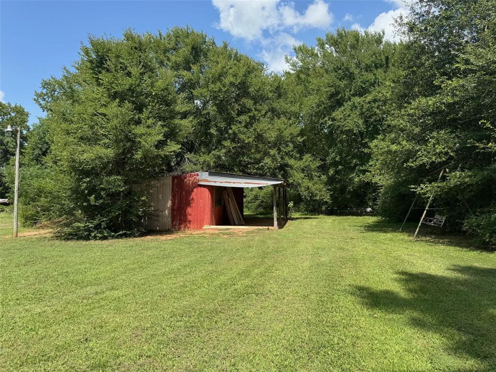 1111 Gilmer Road Winnsboro, TX 75494 - Photo 9 of 11 a house with a yard