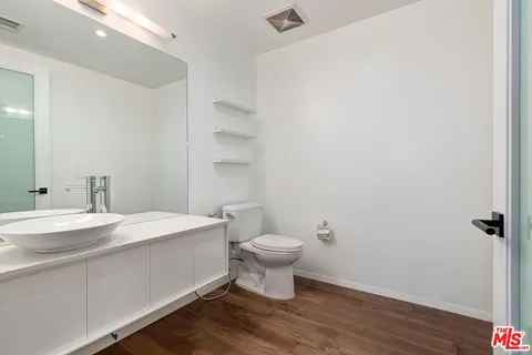 a bathroom with a sink toilet and a mirror