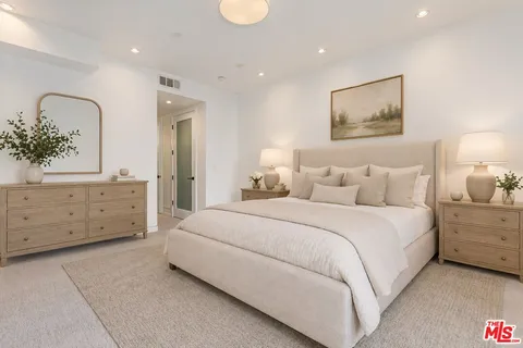 a bedroom with a bed and a night stand