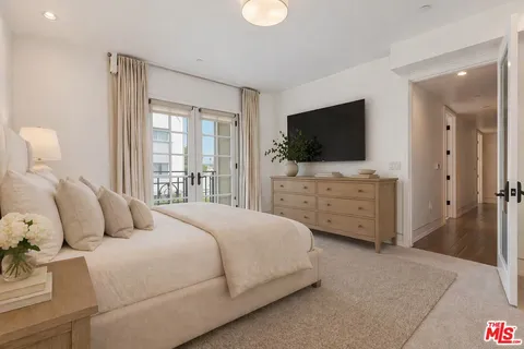 a bedroom with a bed and a flat screen television