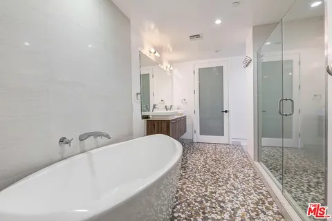 a bathroom with a bathtub and shower