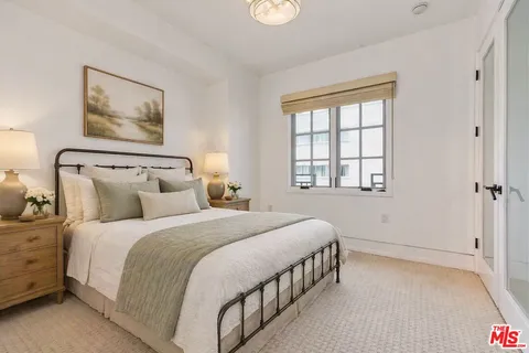a bedroom with bed and a window
