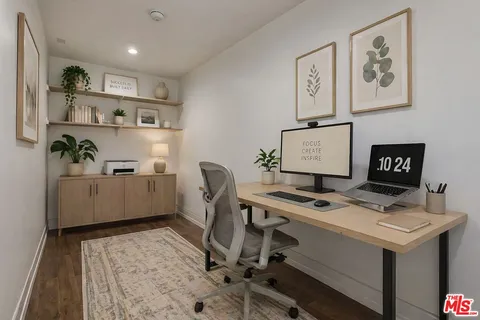 a view of a room with wooden floor
