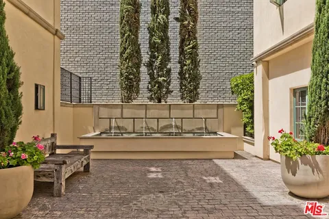 a front view of a residential apartment building with a yard