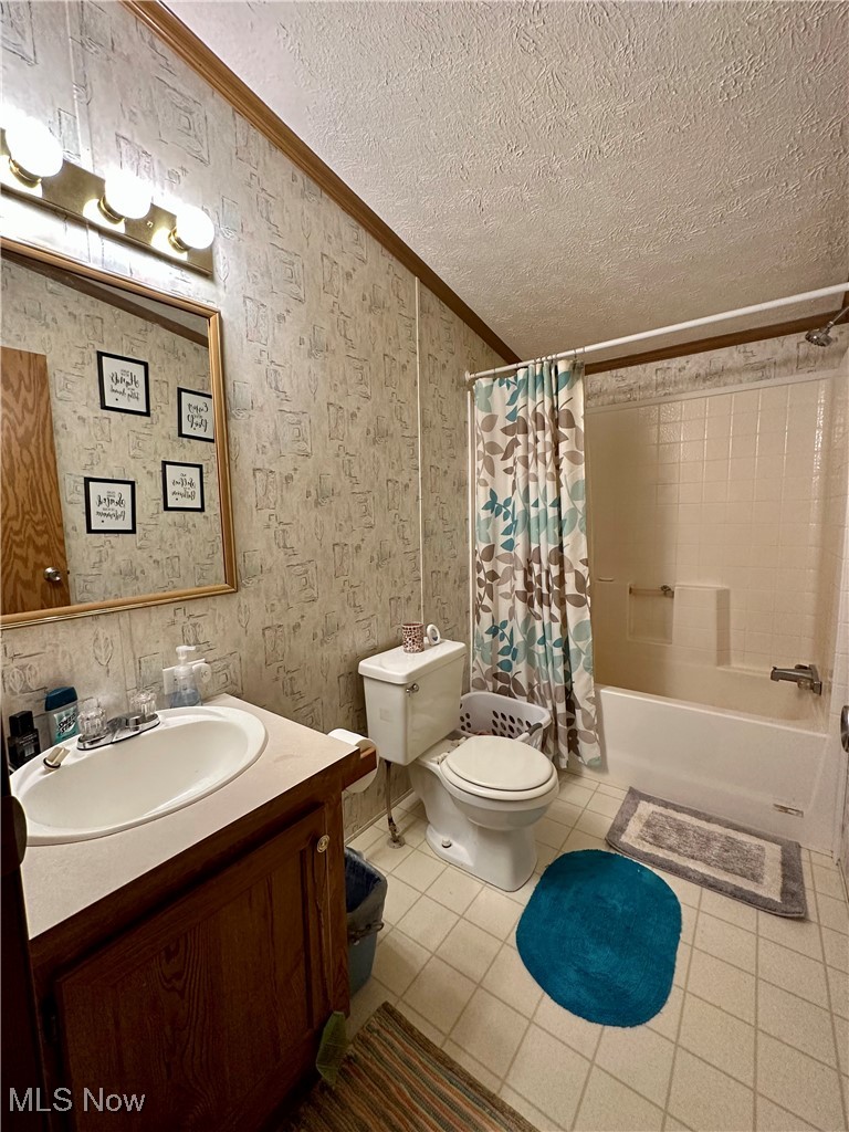 9400 Chalon Road Scio, OH 43988 - Photo 27 of 43 Full bathroom with tile patterned flooring, ornamental molding, toilet, shower / bath combination with curtain, and vanity