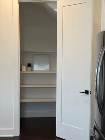 a view of walk in closet with empty racks