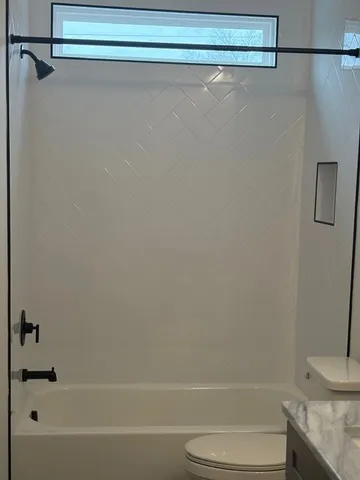 a bathroom with a shower and a toilet