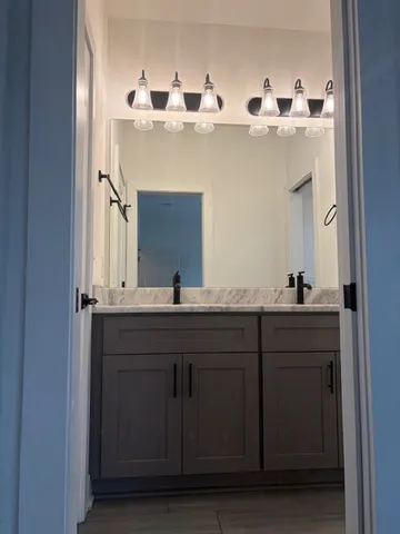 a bathroom with a double vanity sink and mirror