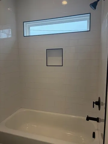 a bathroom with a bathtub and a shower