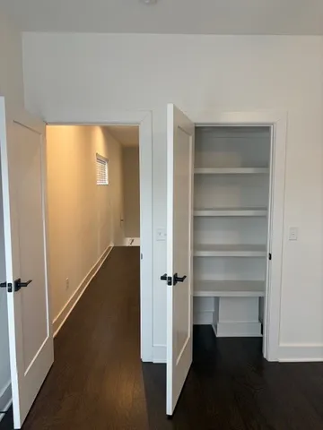 a view of walk in closet with empty racks