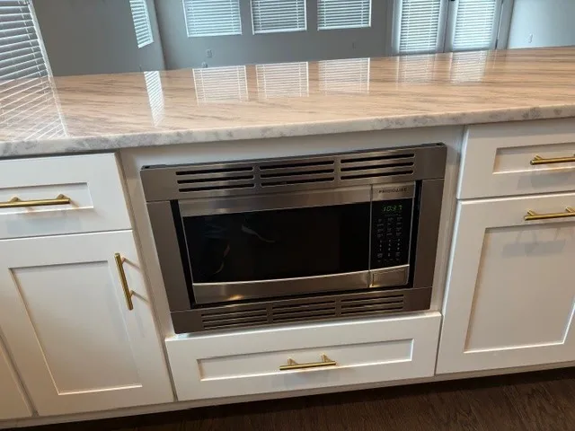 a stove top oven sitting inside of a kitchen
