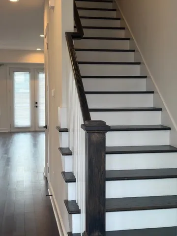 a view of entryway and hall with wooden floor