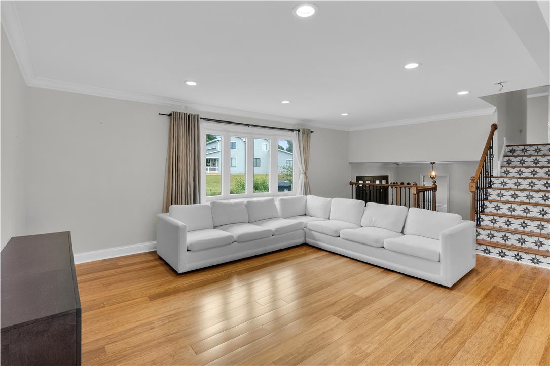 3396 Darien Road Bethlehem, PA 18020 - Photo 18 of 44 Hardwood floors and generous natural light create an inviting atmosphere in this open-concept living space.