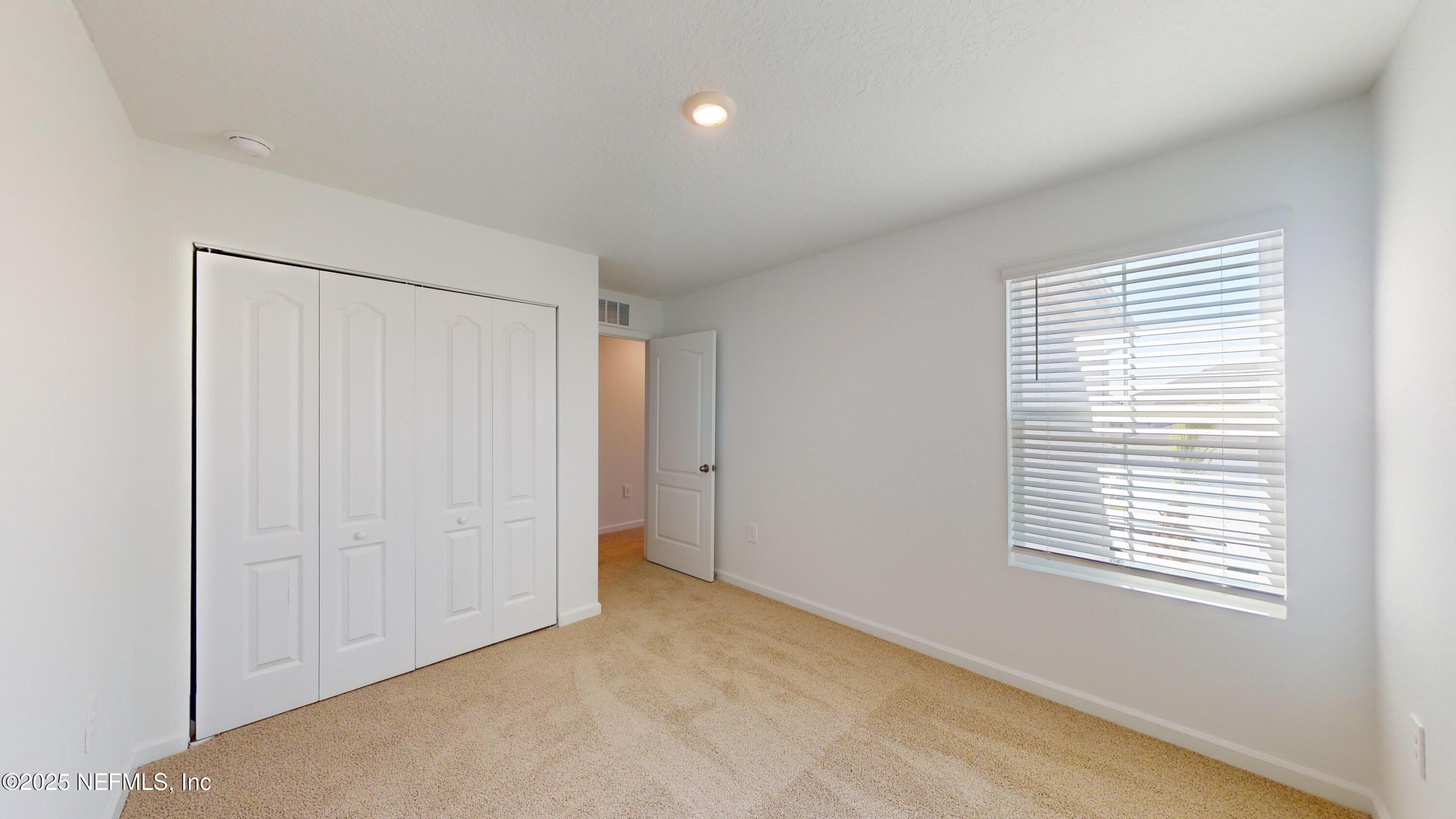 169 Seaport Breeze Road St. Augustine, FL 32095 - Photo 14 of 21 a view of an empty room with a window