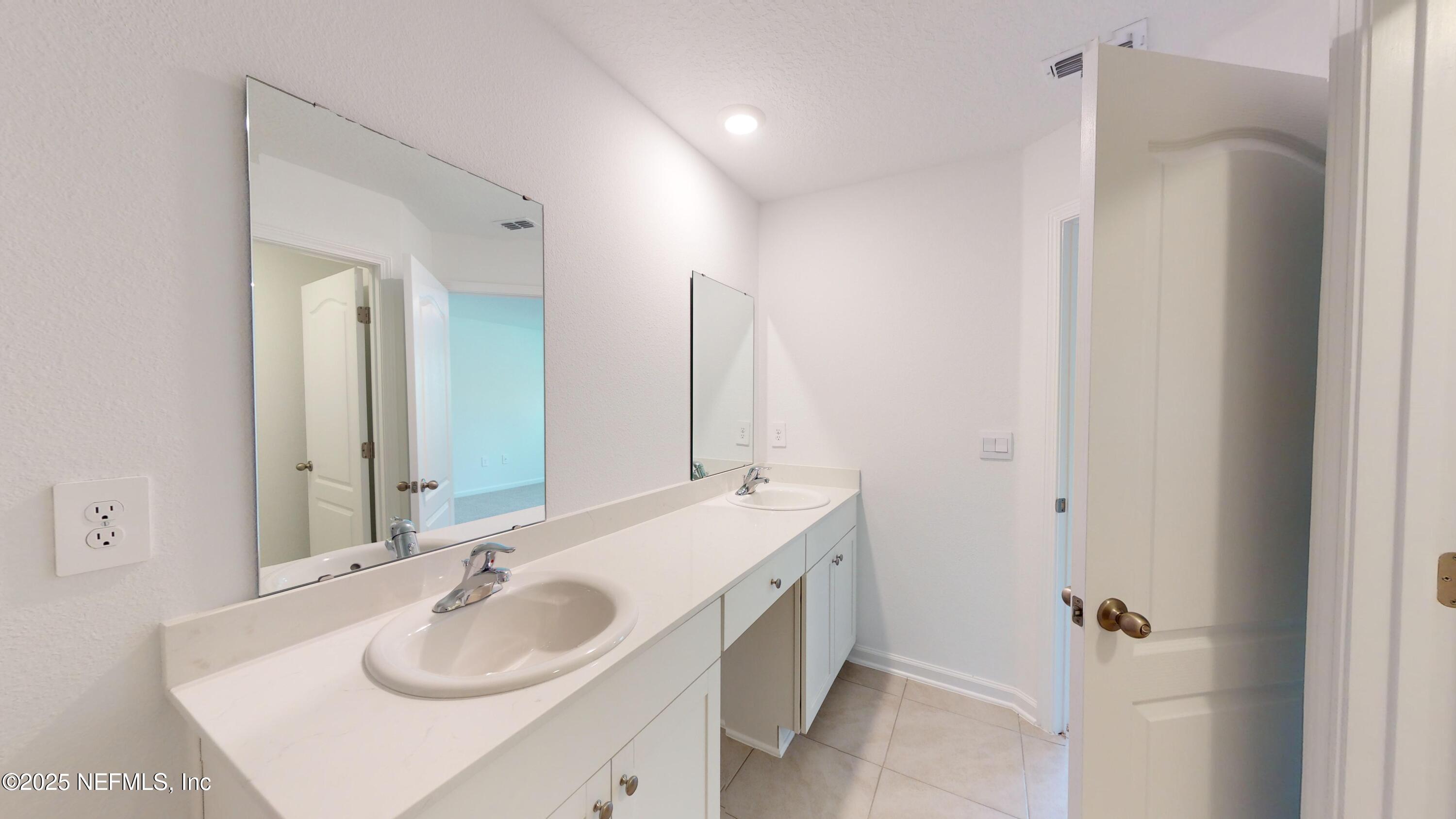 169 Seaport Breeze Road St. Augustine, FL 32095 - Photo 15 of 21 a bathroom with a sink and a mirror