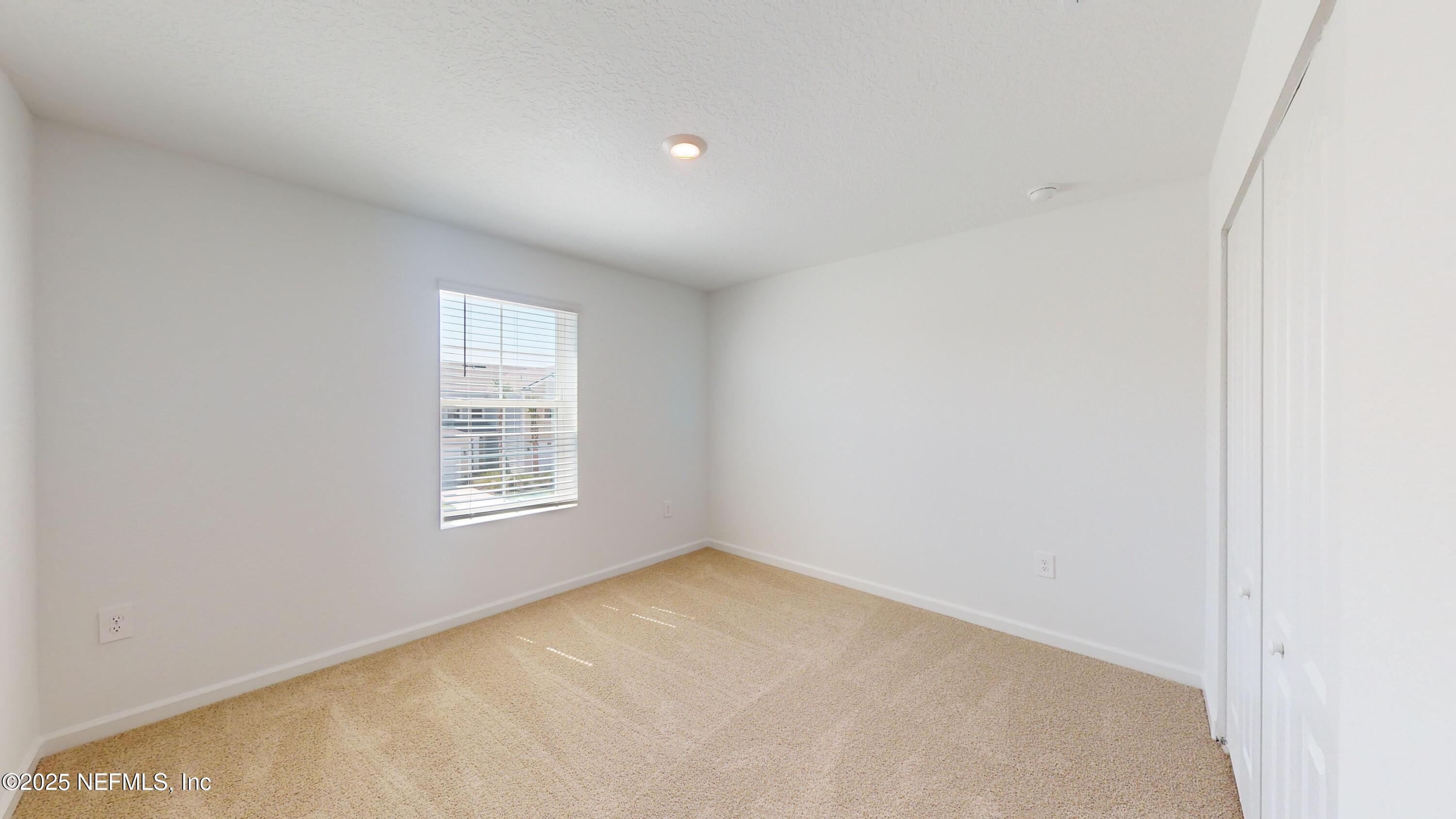 169 Seaport Breeze Road St. Augustine, FL 32095 - Photo 16 of 21 an empty room with a window