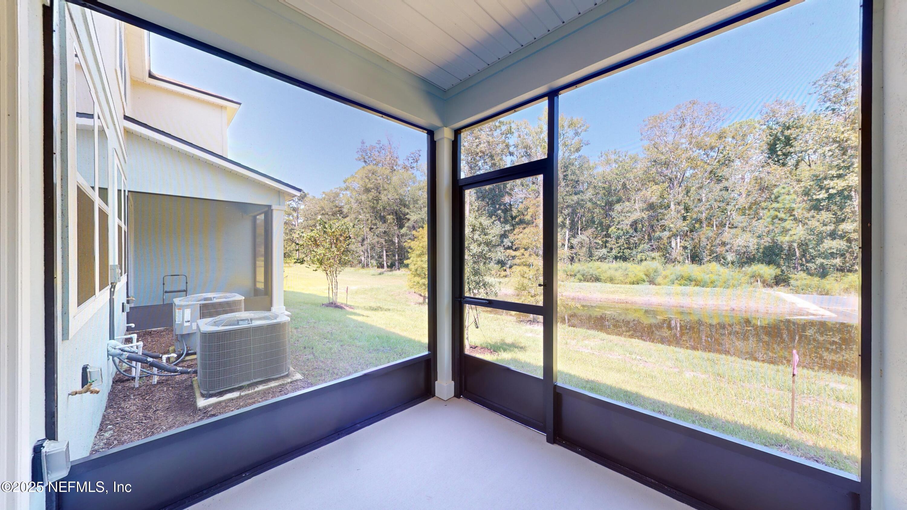 169 Seaport Breeze Road St. Augustine, FL 32095 - Photo 19 of 21 a view of a living room and a floor to ceiling window
