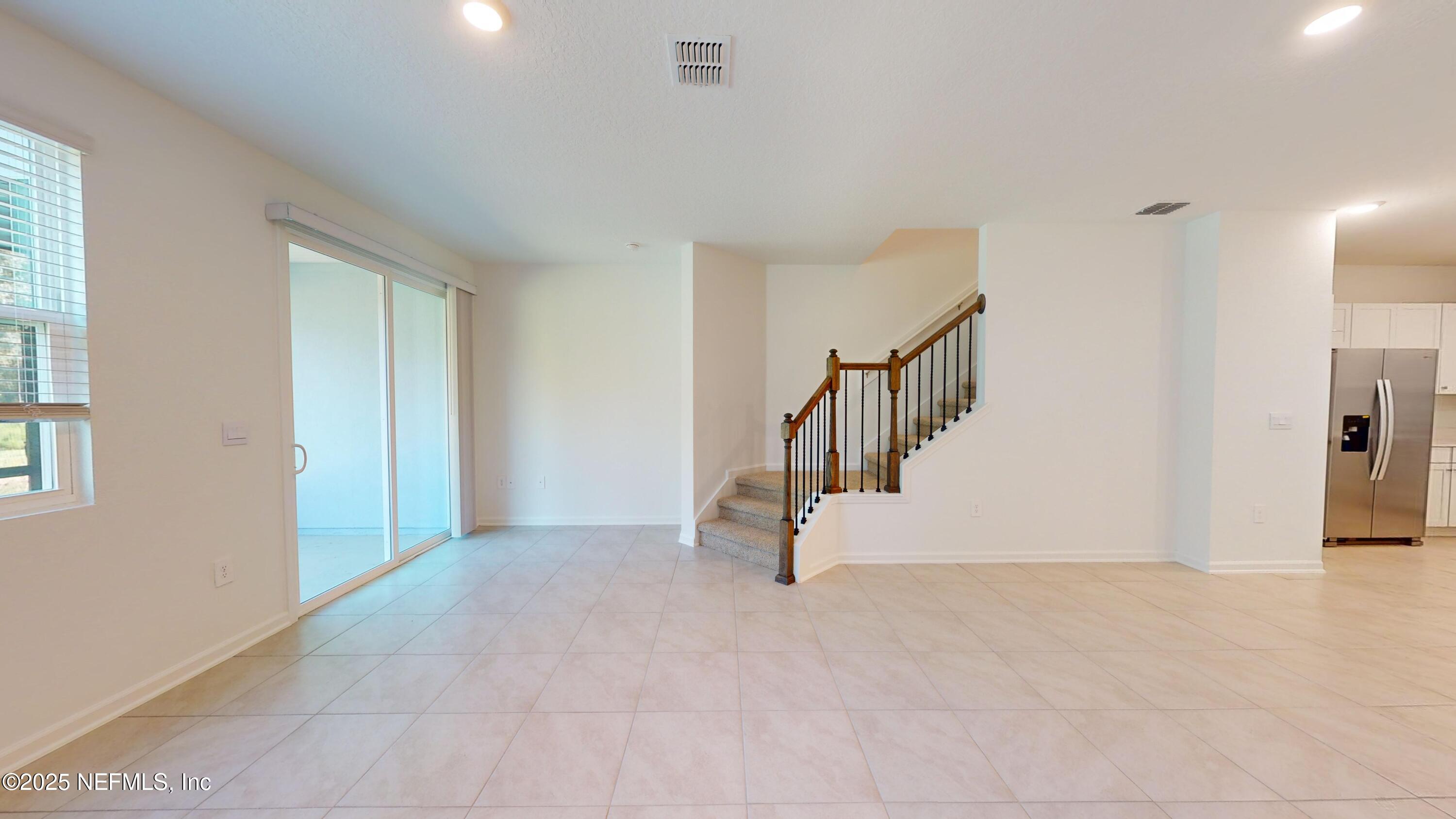 169 Seaport Breeze Road St. Augustine, FL 32095 - Photo 4 of 21 a view of an entryway with staircase