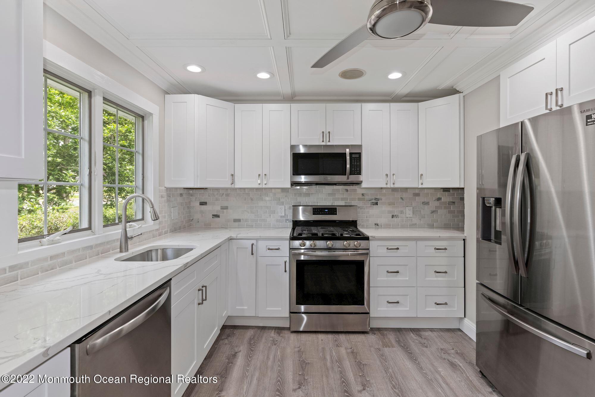 738 Holmdel Road Holmdel, NJ 07733 - Photo 15 of 36 a kitchen with a sink stainless steel appliances and window