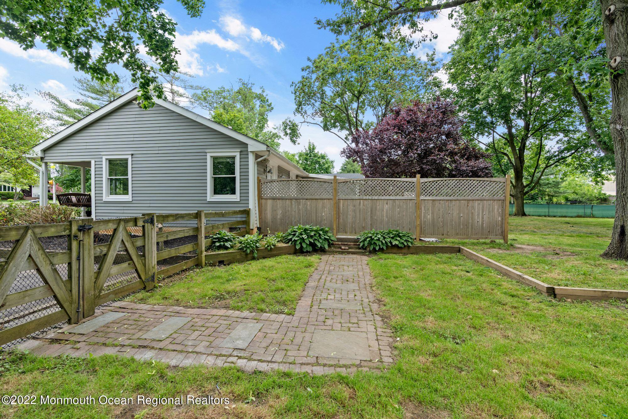 738 Holmdel Road Holmdel, NJ 07733 - Photo 22 of 36 a backyard of a house with table and chairs