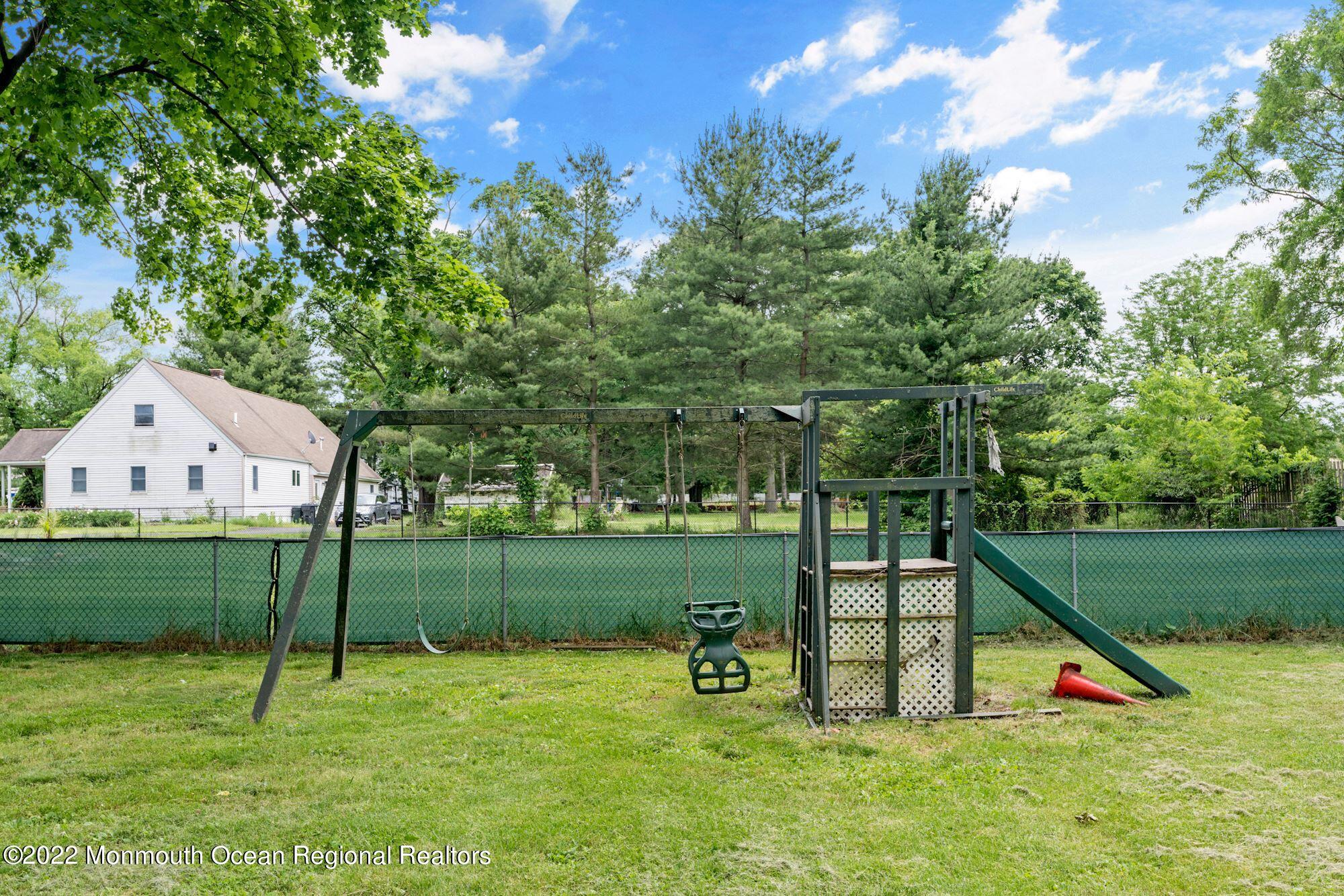 738 Holmdel Road Holmdel, NJ 07733 - Photo 35 of 36 a view of a backyard with a garden and entertaining space